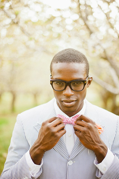 Groom in a blue striped suit with pink chevron bow tie Groom in a blue striped suit with pink chevron bow tie