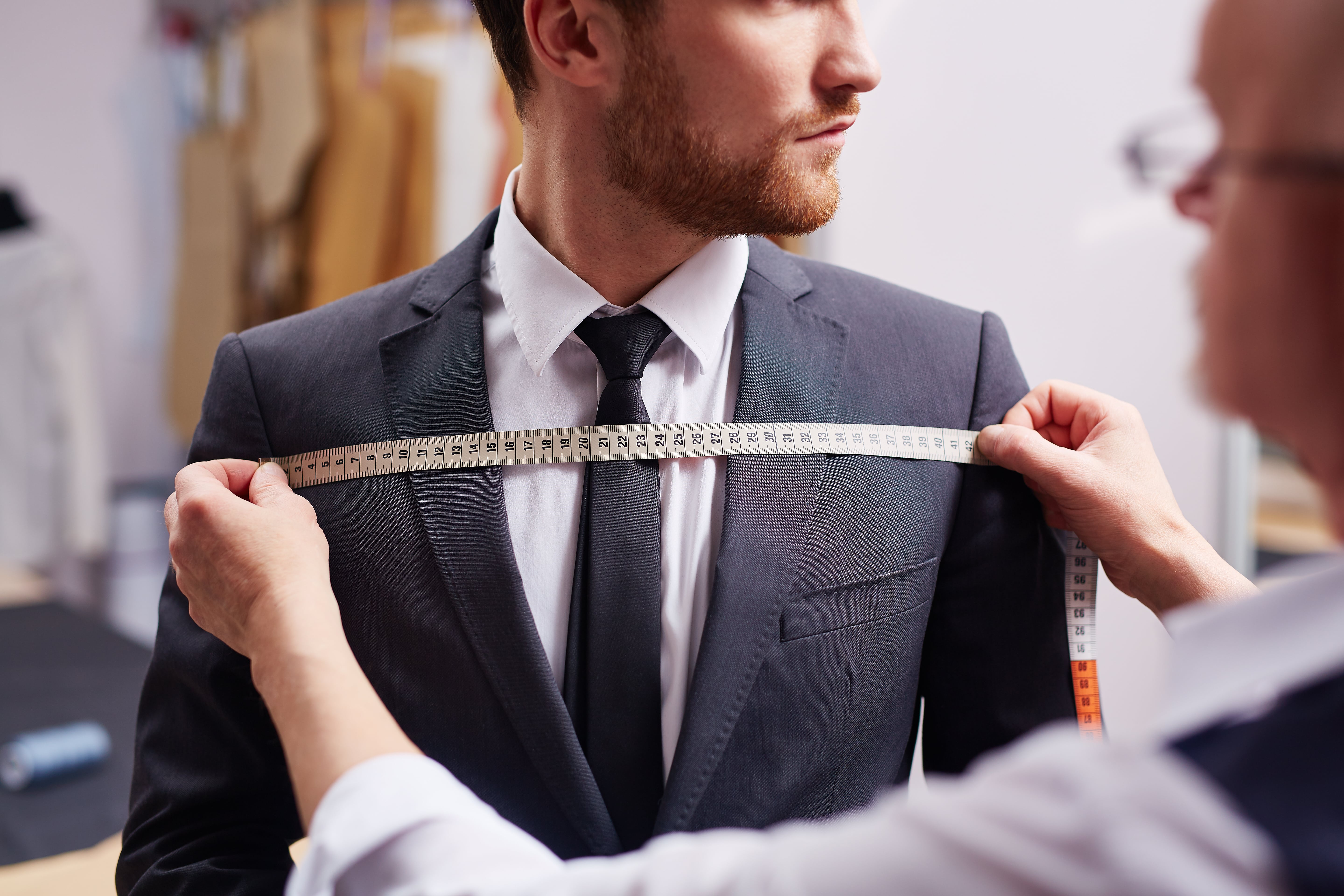 a man getting a custom-made tailored suit a man getting a custom-made tailored suit