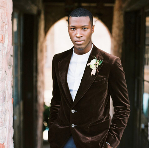 Groom in brown velvet suit jacket and jeans Groom in brown velvet suit jacket and jeans